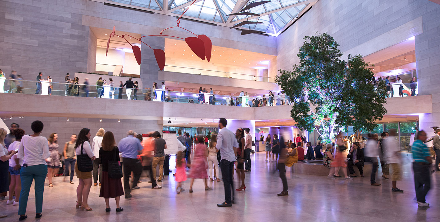 Visitors enjoy a National Gallery Nights program in the East Building Atrium.